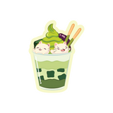 A matcha parfait topped with two mochi cats cartoon sticker