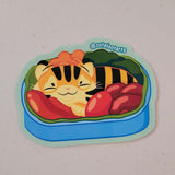 A Japanese bento featuring a cute sleeping tiger made of food.